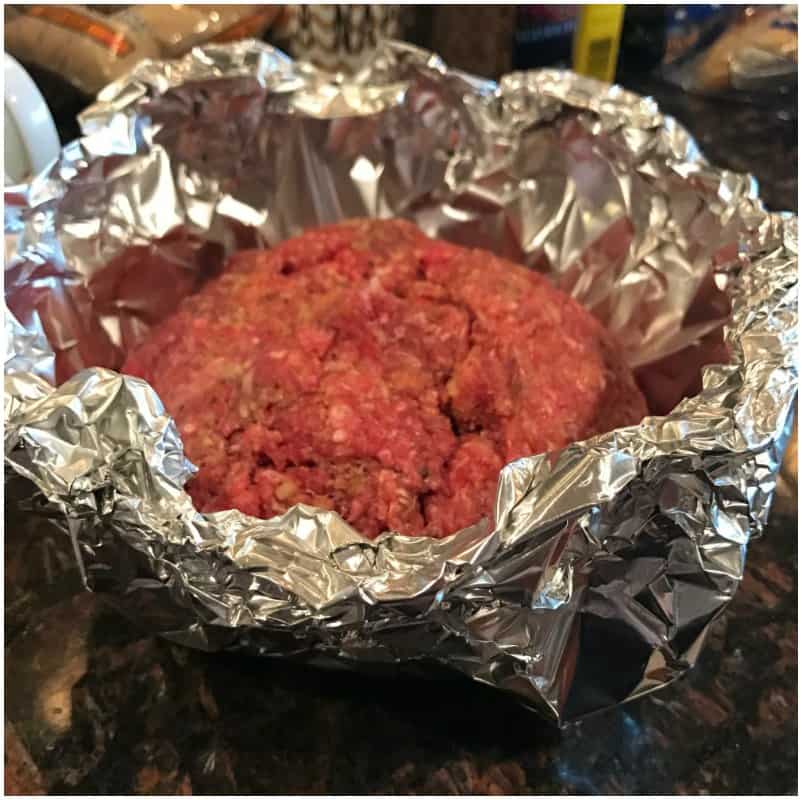 meat loaf with vegetables close-up on a cutting board. vertical