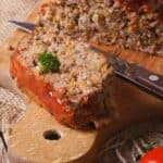 meat loaf with vegetables close-up on a cutting board. vertical