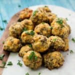 Keto Sausage Balls on a marble tray with parsley garnish