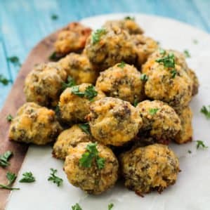 Keto Sausage Balls on a marble tray with parsley garnish