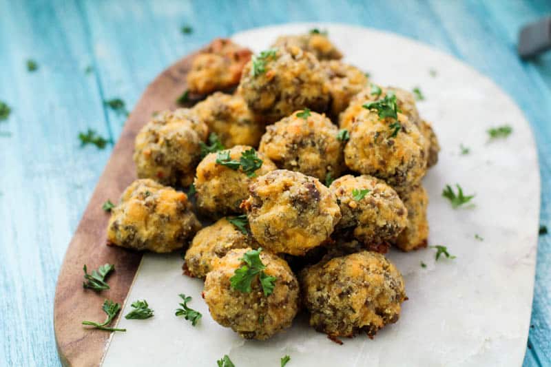 Keto Sausage Balls on a marble tray with parsley garnish