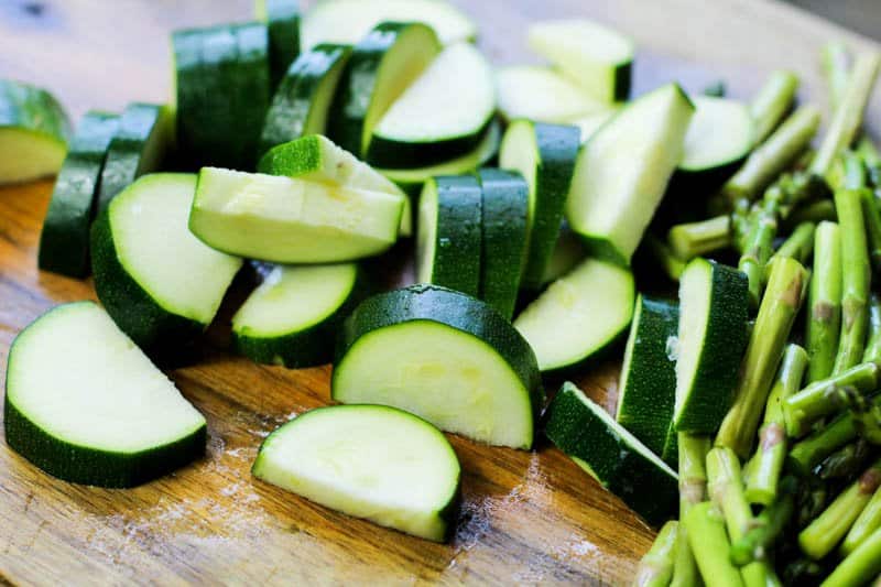 Keto Lemon Garlic Chicken Recipe zucchini cut on a wooden cutting board