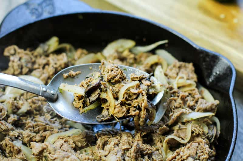 cheese steak mixture in a cast iron pan