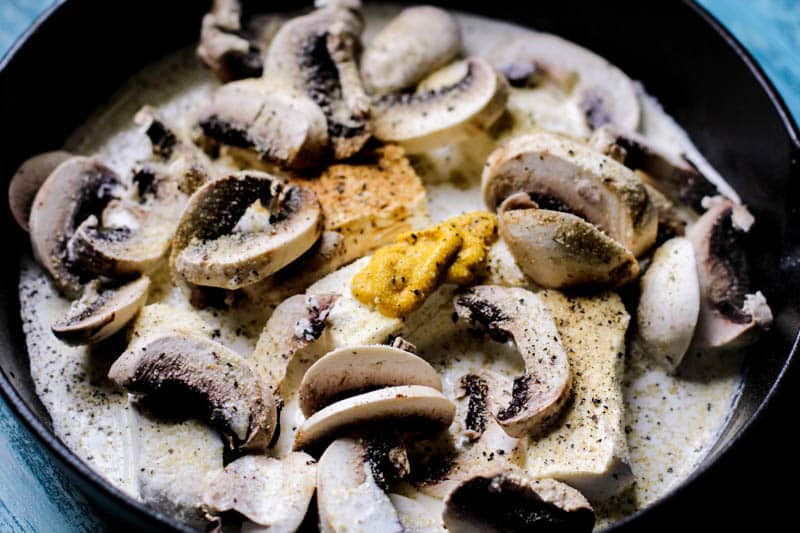 Mushrooms and mustard in a pan.