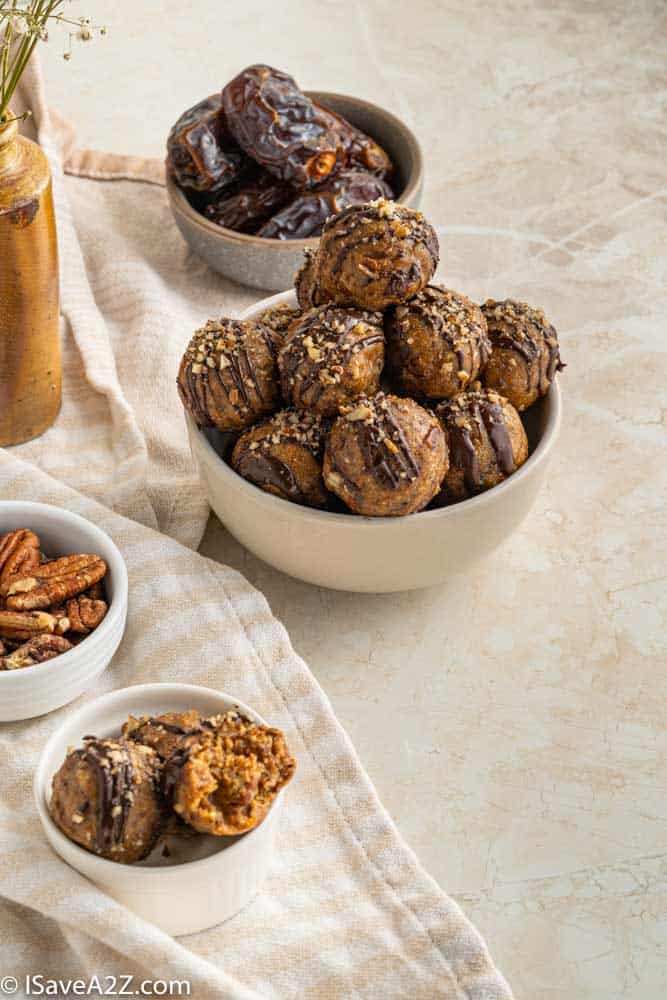 pecan pie truffles in a white bowl with dates and pecans in a bowl nearby