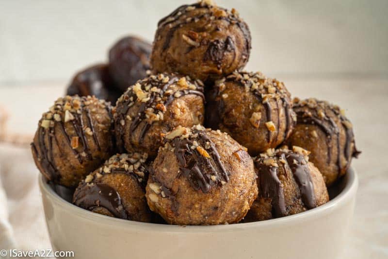 close up side photo of pecan pie truffle balls in a white bowl