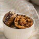 small bowl with pecan pie truffles for the holidays in a white bowl with a bite eaten