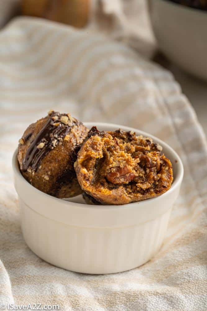 small bowl with pecan pie truffles for the holidays in a white bowl with a bite eaten