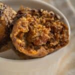 close up photo in a small bowl with pecan pie truffles for the holidays in a white bowl with a bite eaten