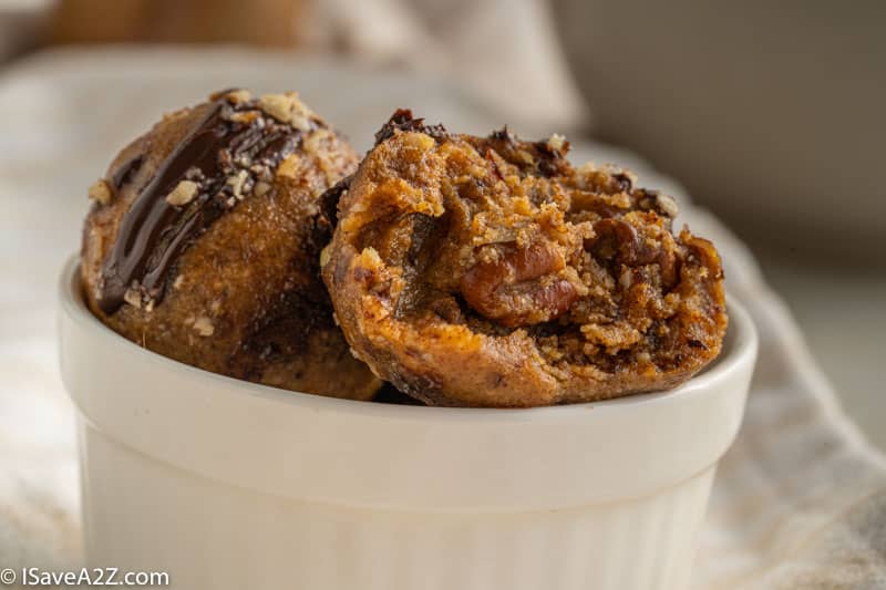 close up photo in a small bowl with pecan pie truffles for the holidays in a white bowl with a bite eaten