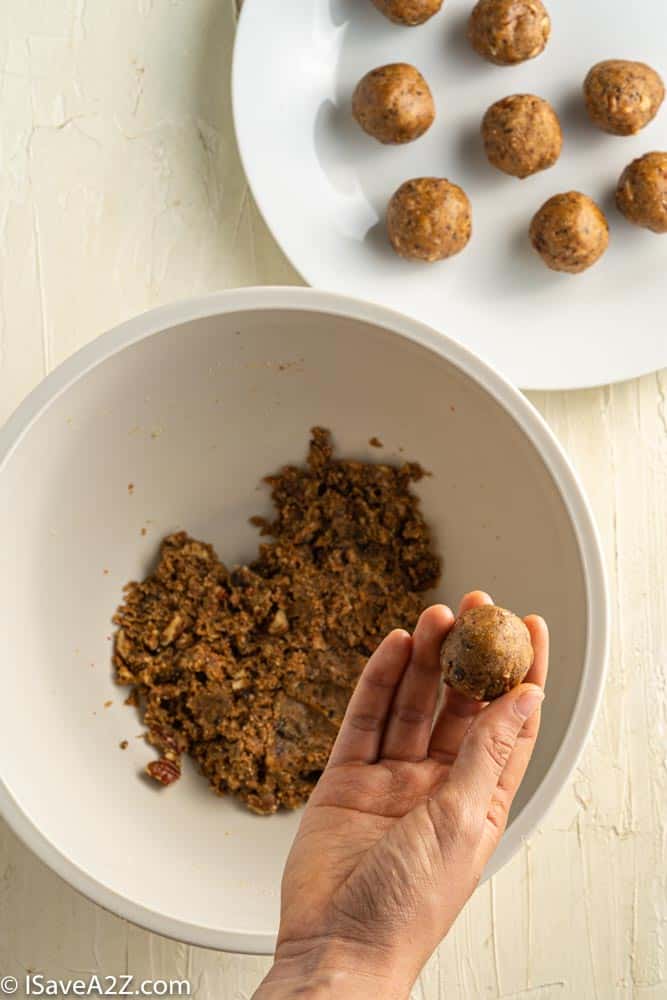 pecan pie truffle batter rolled into a ball with the mixture in the background