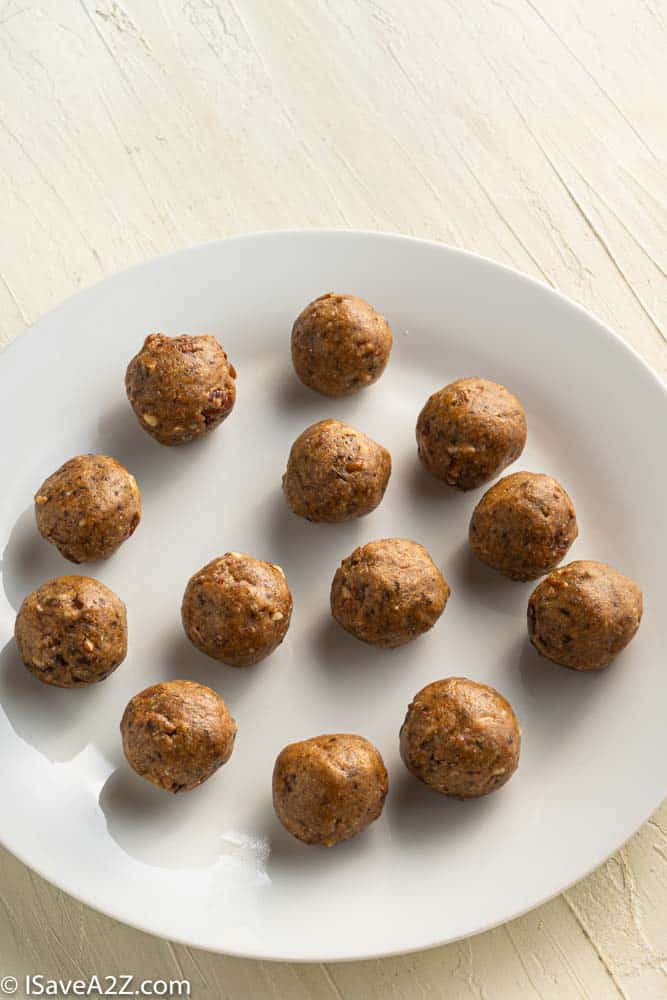 pecan pie truffles rolled into balls on a white plate